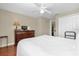 Bedroom featuring wood floors, dresser, closet, and neutral paint at 9440 Myrtle Creek Ln # 1003, Orlando, FL 32832