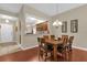 Dining room with wood table and a view into the kitchen at 9440 Myrtle Creek Ln # 1003, Orlando, FL 32832