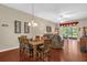 Dining room with wood table, seating for six, and wood floors at 9440 Myrtle Creek Ln # 1003, Orlando, FL 32832