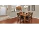Spacious dining room with seating for seven, wood floors, and an open layout at 9440 Myrtle Creek Ln # 1003, Orlando, FL 32832