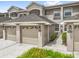 Charming townhome exterior featuring attached garages, neutral color palette, and well-maintained landscaping at 9440 Myrtle Creek Ln # 1003, Orlando, FL 32832