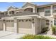 Attached garage with decorative windows and front door access to the home at 9440 Myrtle Creek Ln # 1003, Orlando, FL 32832