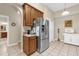 Bright kitchen with stainless steel refrigerator, pantry, and white cabinets with modern appliances at 9440 Myrtle Creek Ln # 1003, Orlando, FL 32832