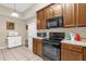 Kitchen featuring black appliances and plenty of counter space at 9440 Myrtle Creek Ln # 1003, Orlando, FL 32832