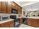 Kitchen featuring black appliances and ample counter space at 9440 Myrtle Creek Ln # 1003, Orlando, FL 32832