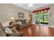 Comfortable living room featuring hardwood floors, a screen door to the screened in patio, and lots of light at 9440 Myrtle Creek Ln # 1003, Orlando, FL 32832