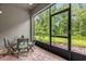 Enclosed patio area with seating and a view of the lush backyard at 9440 Myrtle Creek Ln # 1003, Orlando, FL 32832