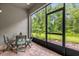 Screened-in patio with brick flooring and a view of the lush green backyard at 9440 Myrtle Creek Ln # 1003, Orlando, FL 32832