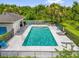 Fenced community pool with sun loungers and clubhouse, offering a relaxing outdoor experience at 9440 Myrtle Creek Ln # 1003, Orlando, FL 32832
