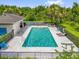 Large community pool with lounge chairs and beautiful landscaping at 9440 Myrtle Creek Ln # 1003, Orlando, FL 32832