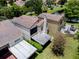 Aerial view showcases a patio, backyard and lush trees surrounding the home and community at 995 Troon Trce, Winter Springs, FL 32708