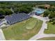 Aerial view of community buildings, including a clubhouse, pool, and putting green at 995 Troon Trce, Winter Springs, FL 32708