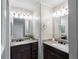 Bathroom featuring dual vanity with granite countertops and modern lighting at 995 Troon Trce, Winter Springs, FL 32708