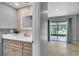 Bathroom vanity with white countertop, wood cabinets, and designer backsplash at 995 Troon Trce, Winter Springs, FL 32708