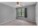 This bedroom is a cozy retreat featuring a ceiling fan and a window to let in natural light at 995 Troon Trce, Winter Springs, FL 32708