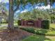Daytime image of the Tusca Willa community sign surrounded by mature landscaping at 995 Troon Trce, Winter Springs, FL 32708