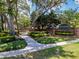 Welcome to Greenbriar: a beautifully landscaped entrance with a brick wall and lush greenery at 995 Troon Trce, Winter Springs, FL 32708