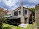 The rear of the home features a screened-in patio and lush greenery around the yard at 995 Troon Trce, Winter Springs, FL 32708