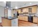 Kitchen boasts stainless steel appliances, wood cabinets, island, and granite countertops at 995 Troon Trce, Winter Springs, FL 32708