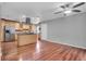 Open concept kitchen features an island with stainless oven and hardwood flooring at 995 Troon Trce, Winter Springs, FL 32708