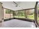 Enclosed lanai with white ceiling fan, tile floors, and screens for enjoying the outdoors at 995 Troon Trce, Winter Springs, FL 32708