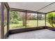 Screened lanai with outdoor view, tile floors, and a white ceiling fan at 995 Troon Trce, Winter Springs, FL 32708