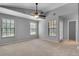 Spacious main bedroom with multiple windows and neutral carpet and paint at 995 Troon Trce, Winter Springs, FL 32708