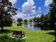 Beautiful pond with fountain surrounded by lush greenery and mature trees in the community at 995 Troon Trce, Winter Springs, FL 32708