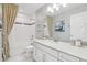 Bright bathroom with a white vanity, a large mirror, and a shower with patterned curtains at 10009 Randal Walk St, Orlando, FL 32832