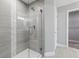 Bathroom featuring walk-in shower with grey tile and glass door at 10009 Randal Walk St, Orlando, FL 32832