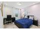 Cozy bedroom featuring a desk area, soft natural light, and light purple walls at 10009 Randal Walk St, Orlando, FL 32832