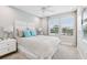 Comfortable bedroom with a headboard, a ceiling fan, and a large window for natural light at 10009 Randal Walk St, Orlando, FL 32832