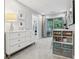 Well-lit bedroom with white dresser, storage shelves and sliding doors to balcony at 10009 Randal Walk St, Orlando, FL 32832