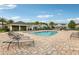Community pool surrounded by lounge chairs and landscaping for a relaxing experience at 10009 Randal Walk St, Orlando, FL 32832