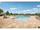 Community pool featuring a wading area, lounge chairs, landscaping, and palm trees at 10009 Randal Walk St, Orlando, FL 32832