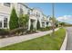 Street view of townhomes with lush landscaping, sidewalks, and a welcoming community vibe at 10009 Randal Walk St, Orlando, FL 32832