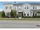 Charming townhome with a well-manicured lawn and colorful exterior paint at 10009 Randal Walk St, Orlando, FL 32832