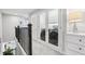 Upstairs hallway with laundry room access and natural light at 10009 Randal Walk St, Orlando, FL 32832