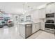 Open kitchen with stainless steel appliances, breakfast bar, and seamless flow to living areas at 10009 Randal Walk St, Orlando, FL 32832