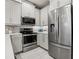 Modern kitchen featuring stainless steel appliances, sleek cabinetry, and stylish backsplash at 10009 Randal Walk St, Orlando, FL 32832
