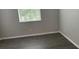 This bedroom features hardwood floors, a window with blinds, and neutral paint at 10604 Savannah Wood Dr # 84, Orlando, FL 32832
