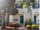 Charming townhome featuring a vibrant green front door and well-maintained landscaping at 10604 Savannah Wood Dr # 84, Orlando, FL 32832