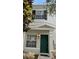 Charming townhome featuring a vibrant green front door and well-maintained landscaping at 10604 Savannah Wood Dr # 84, Orlando, FL 32832