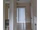 Hallway with neutral walls, tile flooring, and access to multiple rooms at 10604 Savannah Wood Dr # 84, Orlando, FL 32832