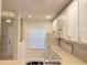 This kitchen features white cabinets, modern appliances, and lots of natural light at 10604 Savannah Wood Dr # 84, Orlando, FL 32832