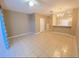 Spacious living room with tile floors, featuring a ceiling fan and ample natural light at 10604 Savannah Wood Dr # 84, Orlando, FL 32832
