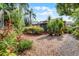 Beautiful backyard with lush greenery, bushes, and a view of the home's exterior at 110 N Brown Ave, Orlando, FL 32801