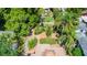 The backyard boasts a beautiful outdoor area with mature trees, flowering plants, and brick accents at 110 N Brown Ave, Orlando, FL 32801
