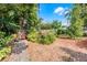 Landscaped backyard with vibrant plants, gravel, mulch, and a cozy seating area at 110 N Brown Ave, Orlando, FL 32801