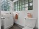 Bathroom featuring a tiled floor, white vanity, and glass block window at 110 N Brown Ave, Orlando, FL 32801